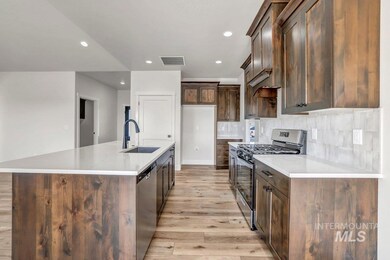 Kitchen with stainless steel appliances, light wood-style floors, decorative backsplash, recessed lighting, and dark brown cabinets