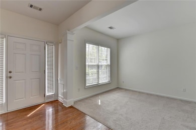 Entryway featuring visible vents, ornate columns, 