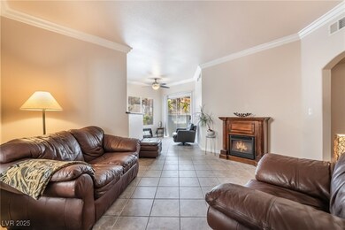 Living room featuring ornamental molding, light ti