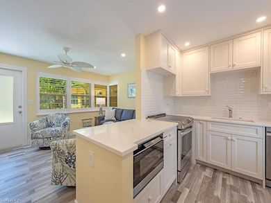 The peninsula countertop offers an inviting space for guests to mingle and gather.