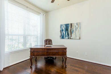 French doors welcome you into the study where rich Hickory hardwood floors blend beautifully with the lighter paint tones and new 2020 airy 108
