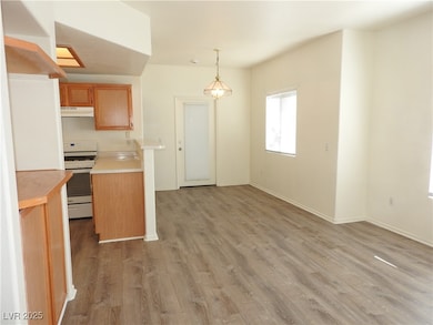Kitchen with white gas range oven, light counterto