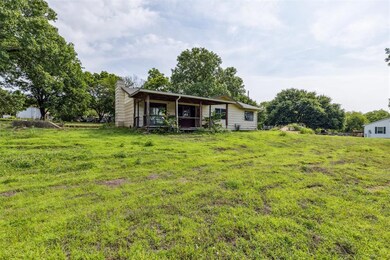 Back of property featuring a yard and a chimney