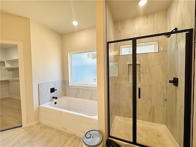 Large walk in tile shower and tub
