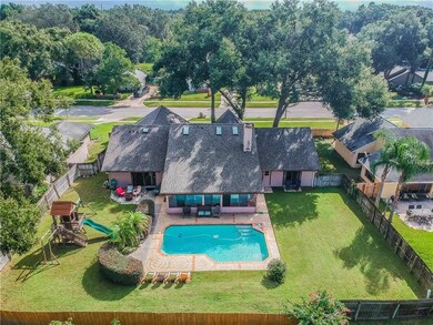 Rear aerial view highlighting the pool, deck, expa