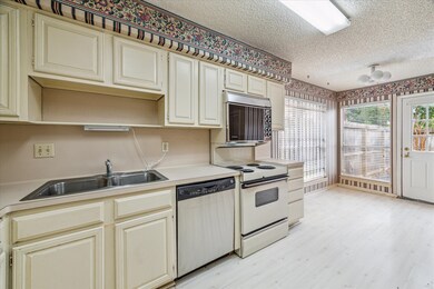 Kitchen with breakfast nook and access to private patio.