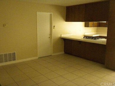 BETWEEN KITCHEN AND LIVING ROOM / GARAGE ENTRY