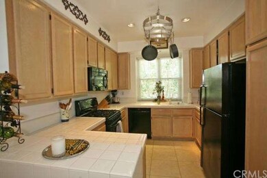 Meticulously maintained kitchen looks outdoors to 