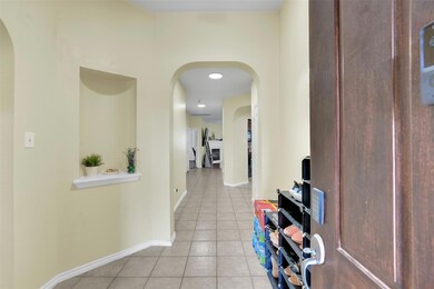 Hall featuring light tile floors