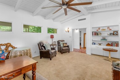 Sitting room featuring ceiling fan, light colored carpet, and wood ceiling