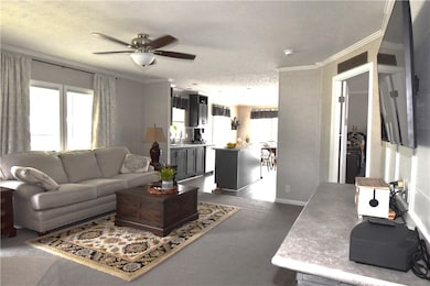 Living room with view into kitchen.