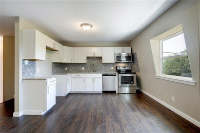 Kitchen with stainless steel appliances, dark woo