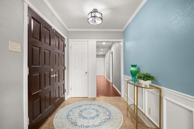 Foyer with light tile patterned floors, ornamenta