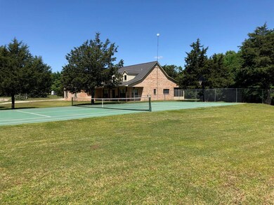 Tennis court with basketball goal