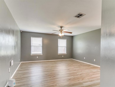 Living room featuring a ceiling fan and light luxury vinyl flooring
