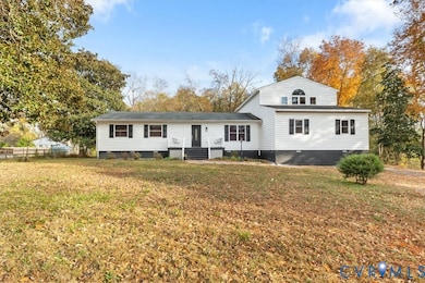 View of front of house with crawl space and a front lawn