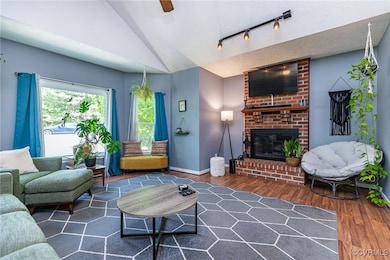 Family room featuring vaulted ceiling, wood finish