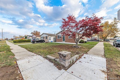 View of front of property featuring a front yard, a residential view, and brick siding