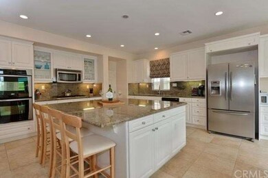 Idyllic granite island & abundant cabinetry