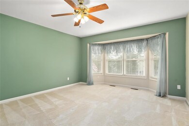 Roomy master w bay windows.