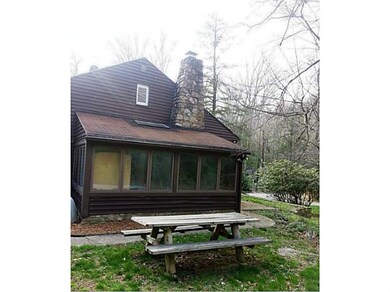 Exterior Back. Three season room is lined with win