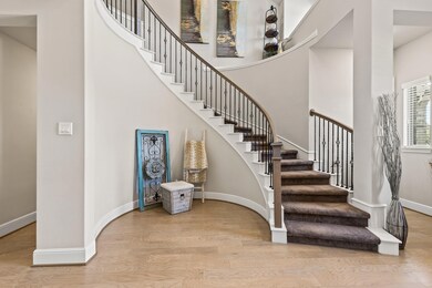 Elegant entryway with a sweeping staircase featuri