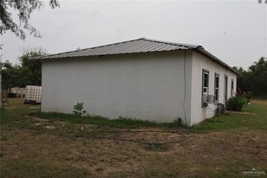 View of side of home with a yard