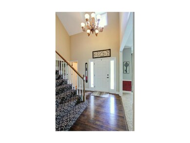 This spacious entryway features hardwood flooring,