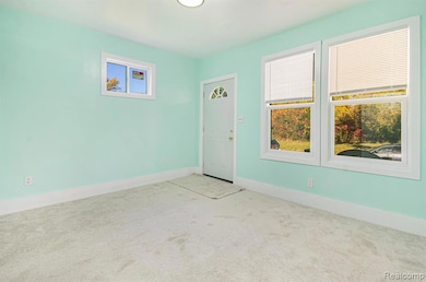 Carpeted empty room with baseboards