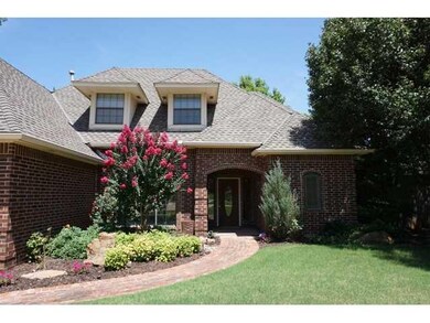 Exterior Front. Mature trees and shrubs heighten t