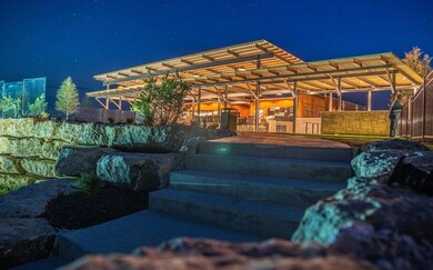 Patio at night featuring an exterior structure