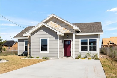 View of front of property with a shingled roof