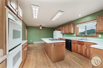 Kitchen island, cherry cabinrts and wood floors