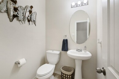 The half bath and utility room are conveniently located near the entryway