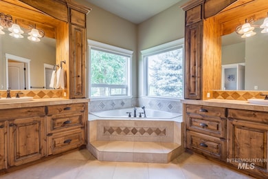Full bathroom with vanity, a bath, decorative backsplash, and tile patterned flooring
