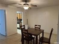 Dining space with ceiling fan and light tile patterned floors