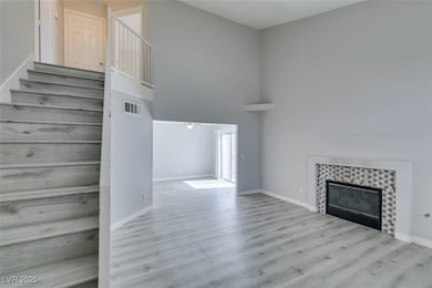 Unfurnished living room featuring a fireplace, bas