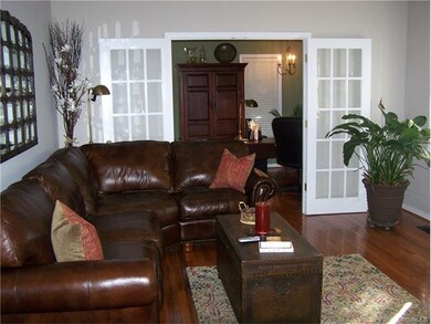 Family room with French doors leading to the forma