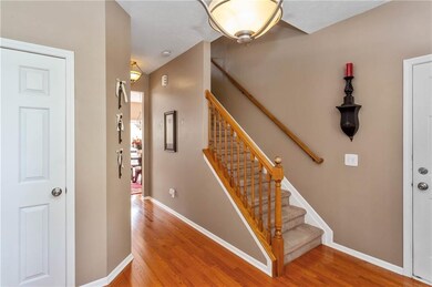 Beautiful NEW hardwood floors! Foyer coat closet on left and garage entry on the right