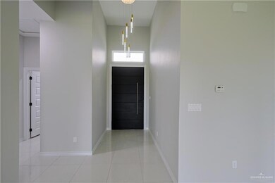 Tiled entrance foyer featuring a high ceiling