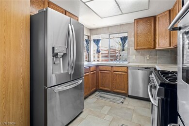 Stainless steel appliances in sunny kitchen.
