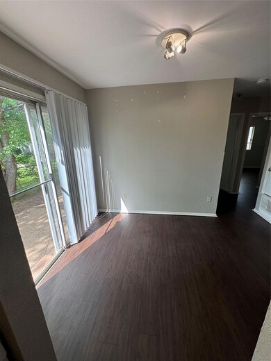 Empty room featuring baseboards and dark wood-sty