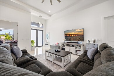 Living room with a high ceiling, a ceiling fan, fr