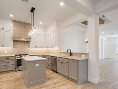 Kitchen featuring light countertops, gray cabinetr