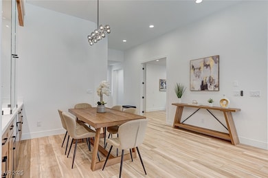Dining area with light wood-style floors and reces