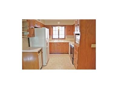 Spacious kitchen equipped with stove, refrigerator