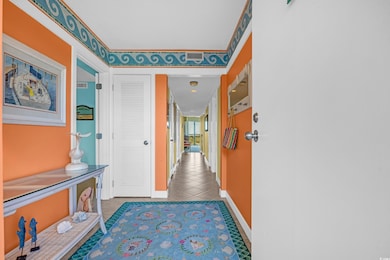 Corridor featuring tile patterned floors and baseb