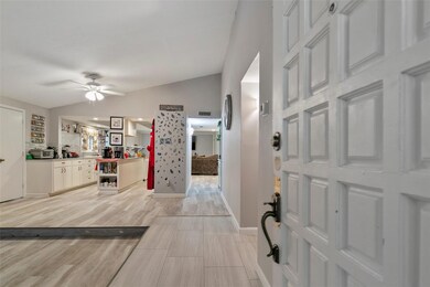 Entrance foyer with kitchen ceiling fan, vaulted c