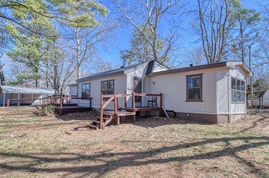 Back of property with a wooden deck