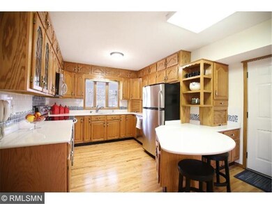 Kitchen offers tile backsplash, stainless steel ap